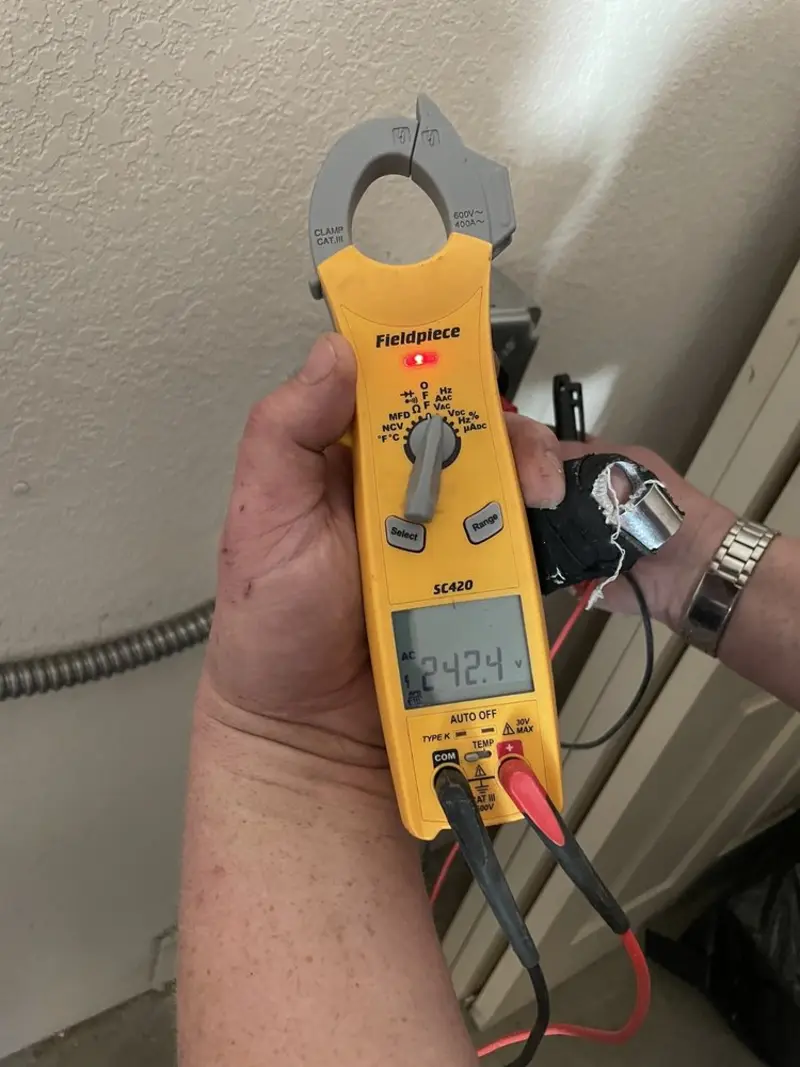 Voltage testing with clamp meter during Outlet Installation in Melody Hill